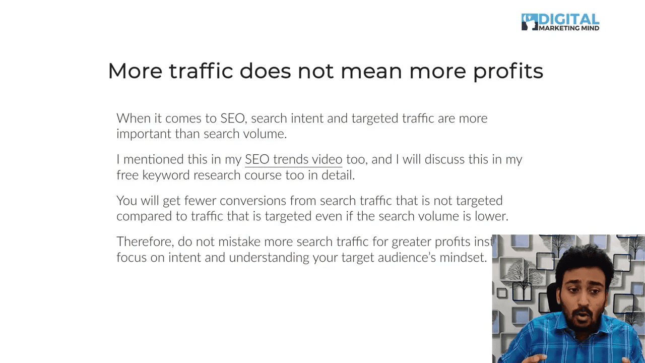 Presentation slide reading 'More traffic does not mean more profits' with explanatory bullet text and a small presenter inset in the lower-right.
