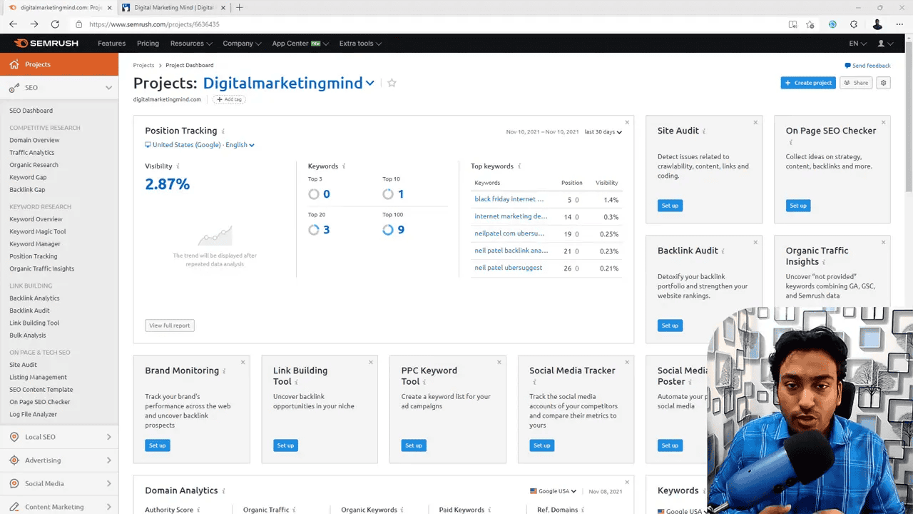 Semrush Projects dashboard showing the Site Audit tile and other project widgets with a presenter video overlay